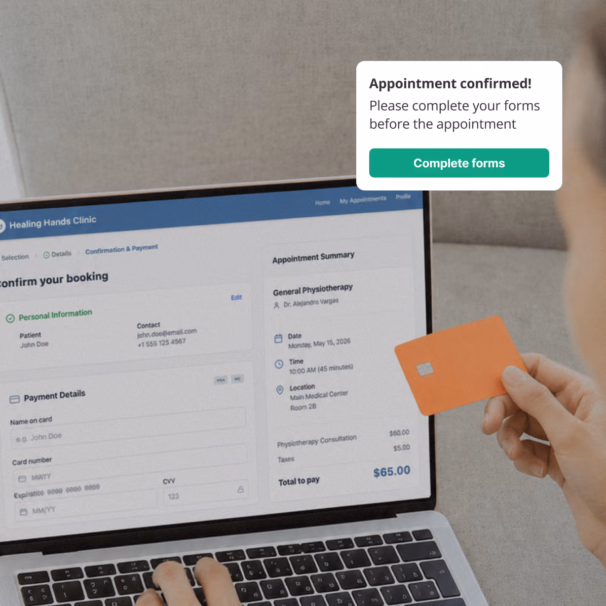 Person holding an orange credit card and entering payment details on a laptop screen for a physiotherapy appointment booking.