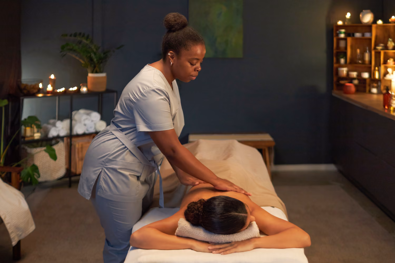 Massage therapy room with practitioner and patient