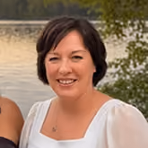 Nicole Lasko smiling outdoors by the water.