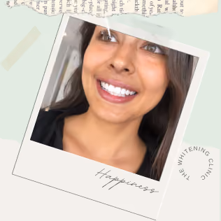 Close-up of a smiling woman with bright white teeth, dark hair, and brown eyes, against a light background with decorative paper elements and the word 'Happiness' scripted below the photo.