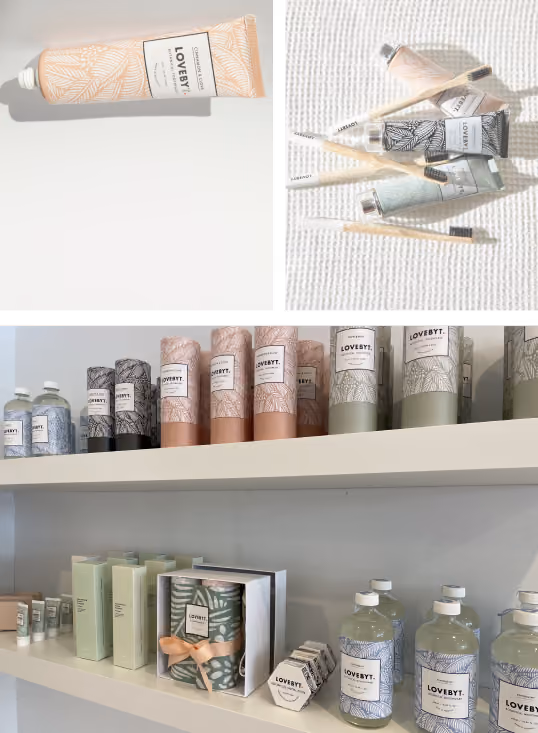 Collage of LOVEYT brand skincare products including a peach-colored tube of cream, toothbrushes with matching patterned toothpaste tubes in peach, black, and green on a textured white surface, and shelves displaying various LOVEYT products like bottles, tubes, boxes, and hexagonal containers in coordinated pastel and neutral colors.