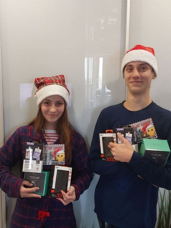 Two students holding power banks and lights