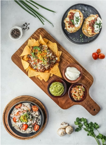 A strange combination meal made up of loaded nachos and baked potatoes.