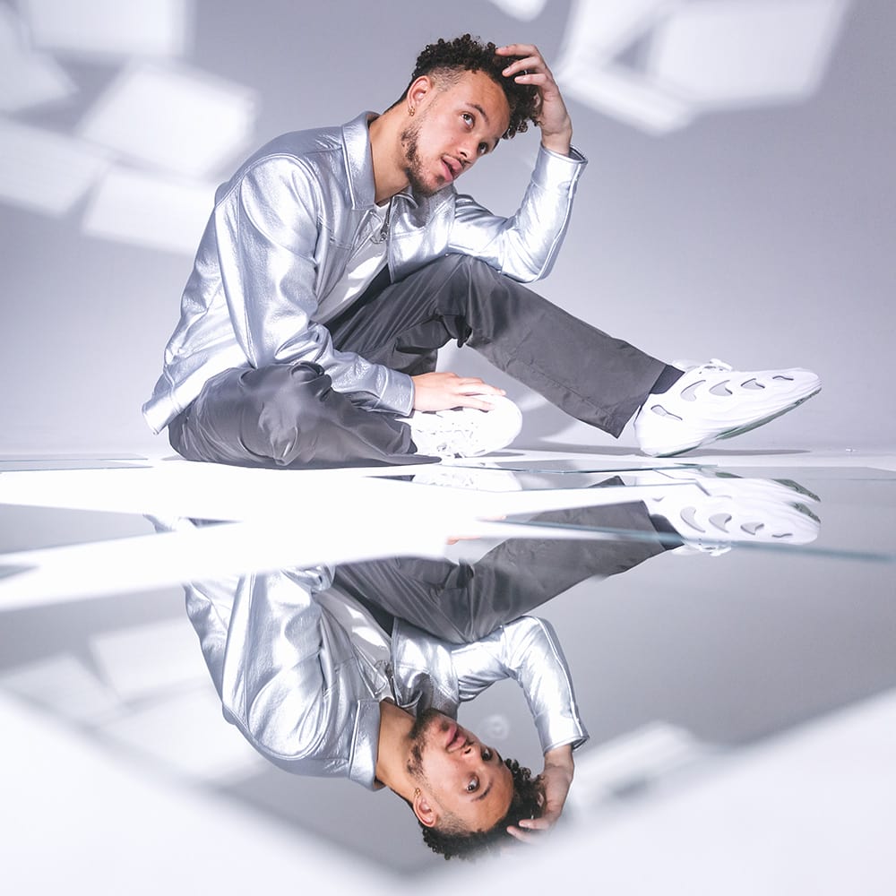 Vincent Darby sitting while looking through multiple square mirrors
