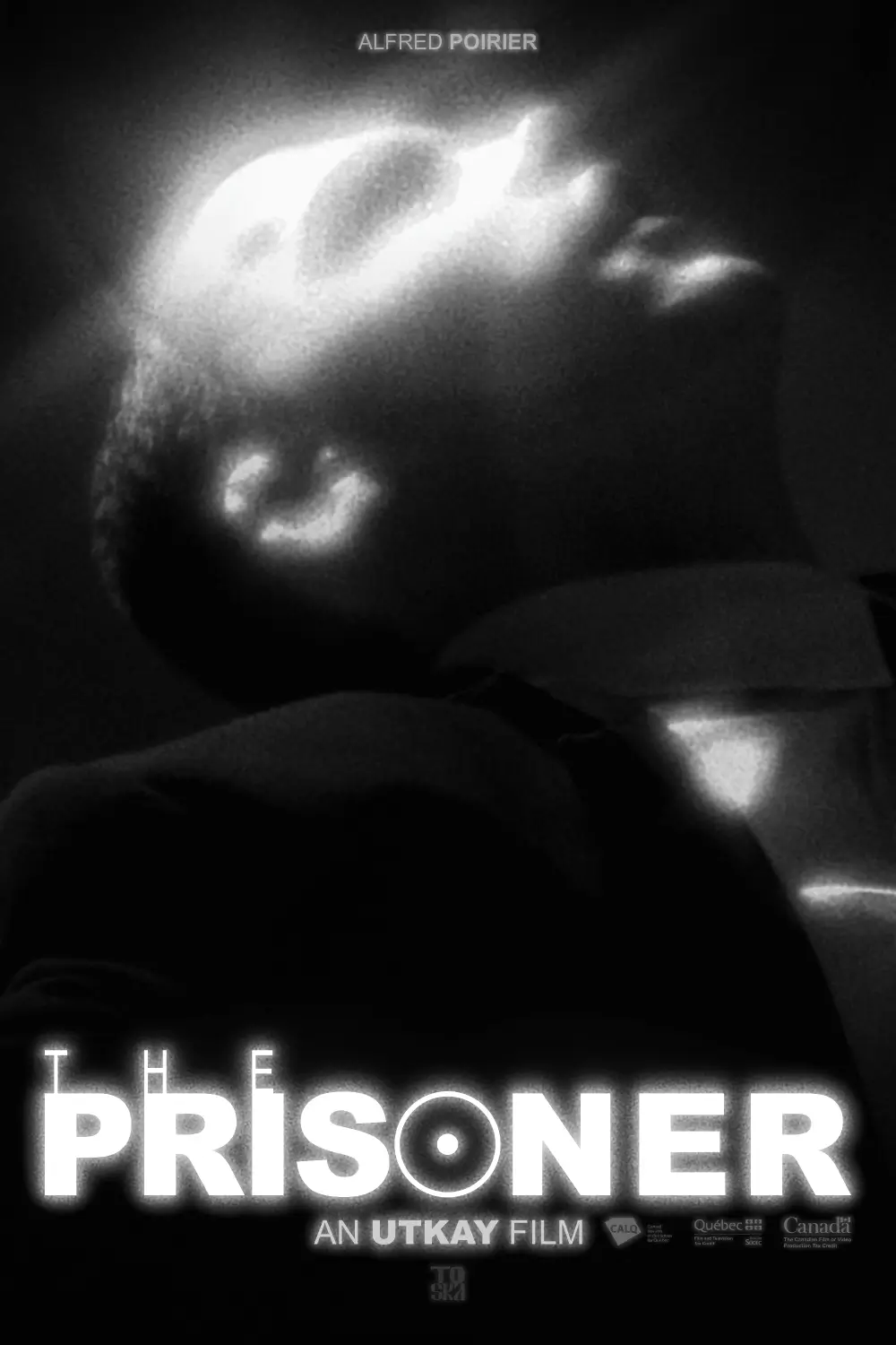 Black and white image of a man leaning backward with bright light patterns on his face and neck, with the text 'The Prisoner' and film credits.