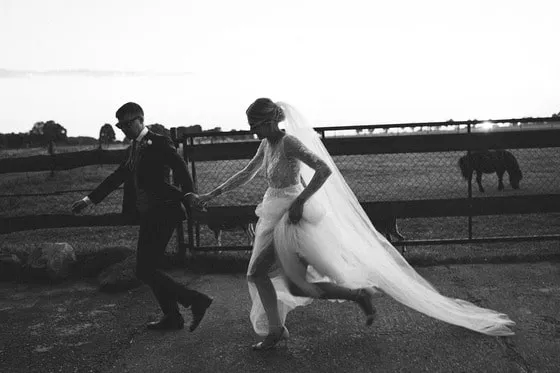 newlyweds run on fields