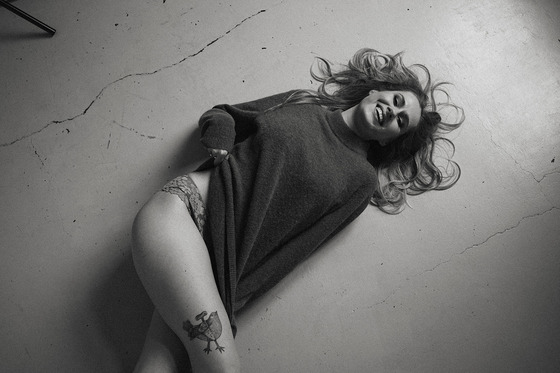 young woman posing on the floor