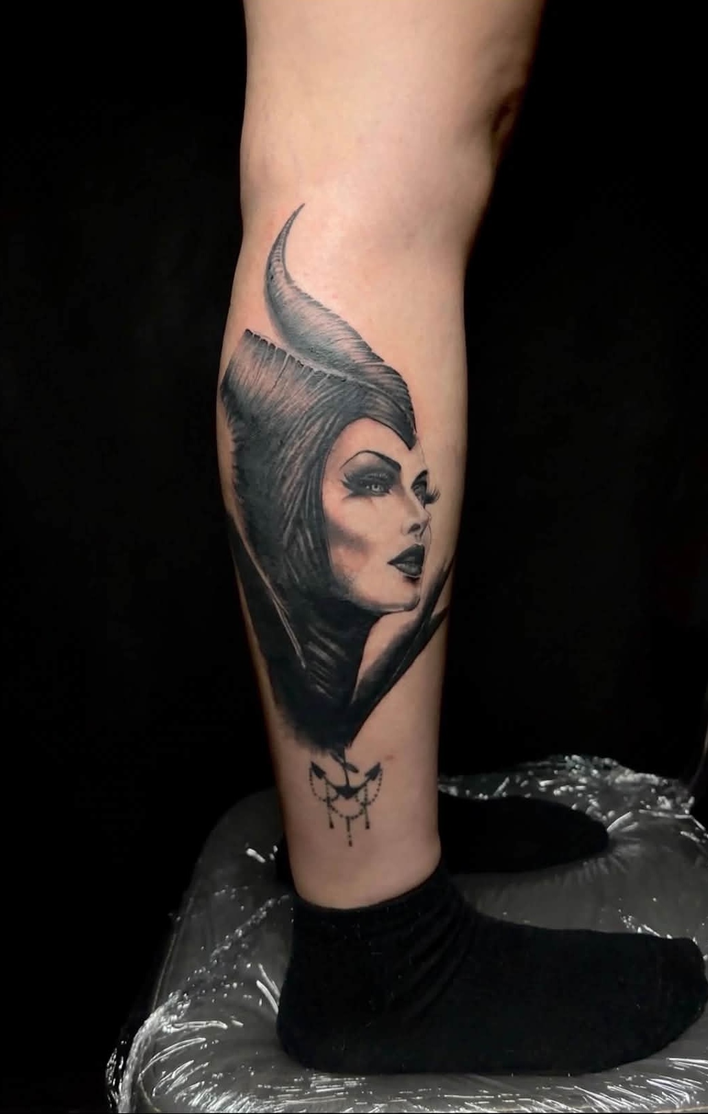 Maleficent black and white leg tattoo