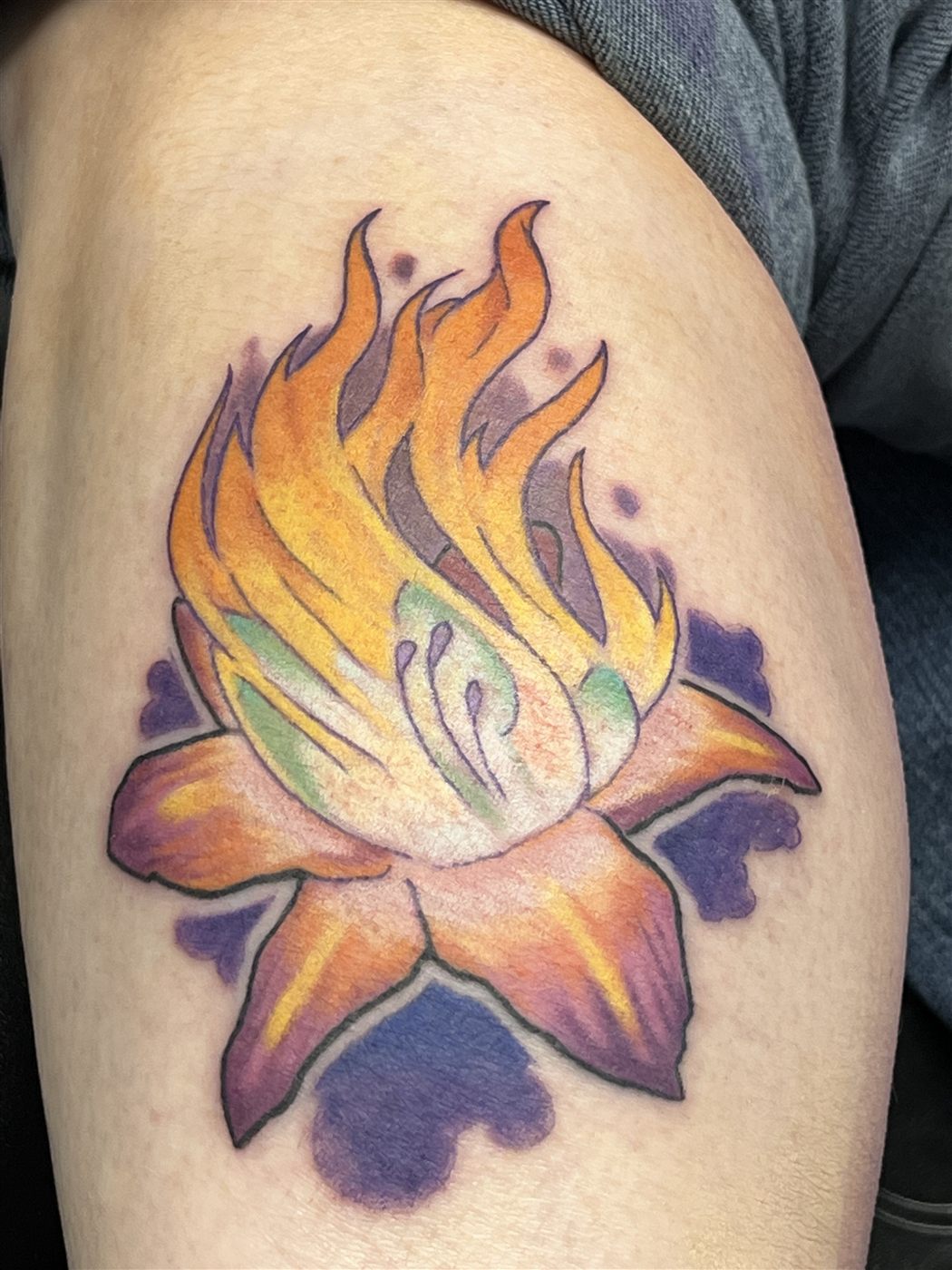 Lotus flower in orange flames, color tattoo