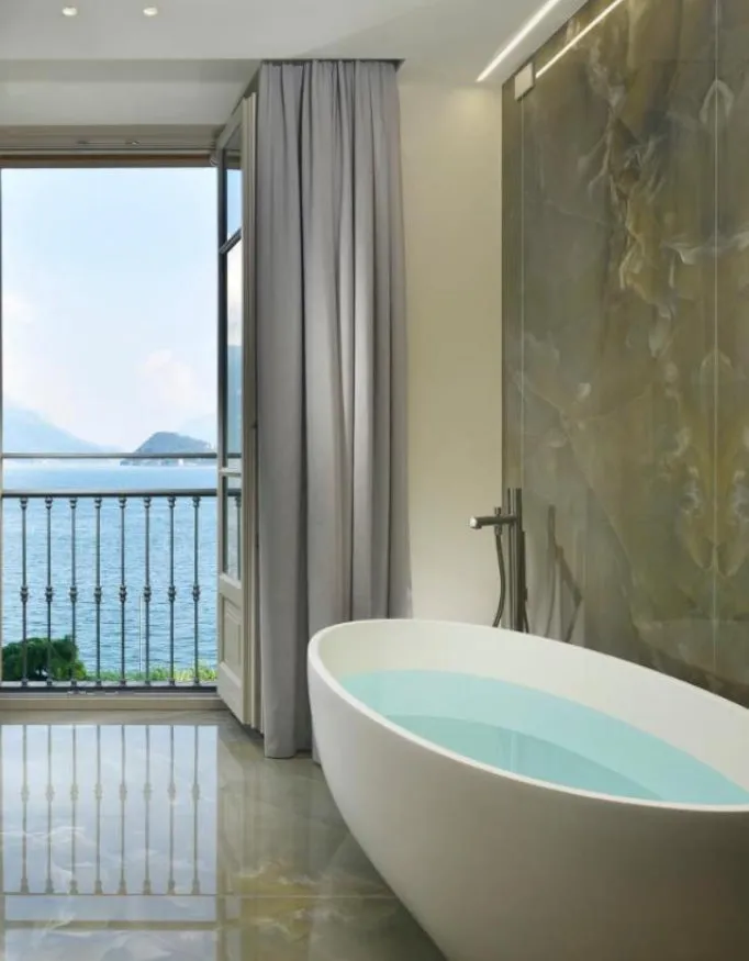 Enjoy a bath with a beautiful view at the Italian lake from a suite at the Grand Hotel Victoria Concept & Spa.