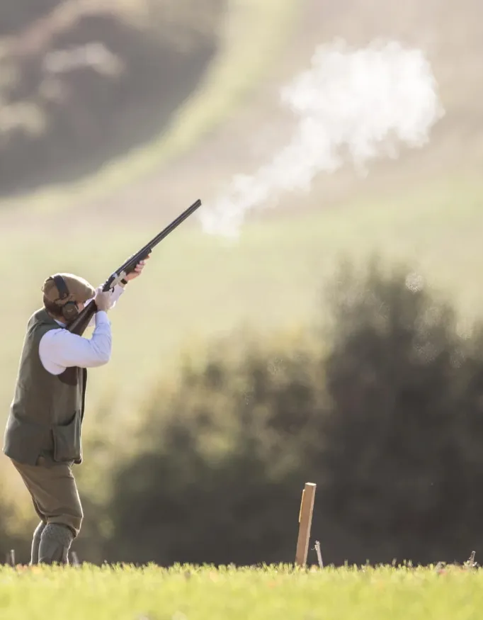 A man practices his clay pigeon shooting.