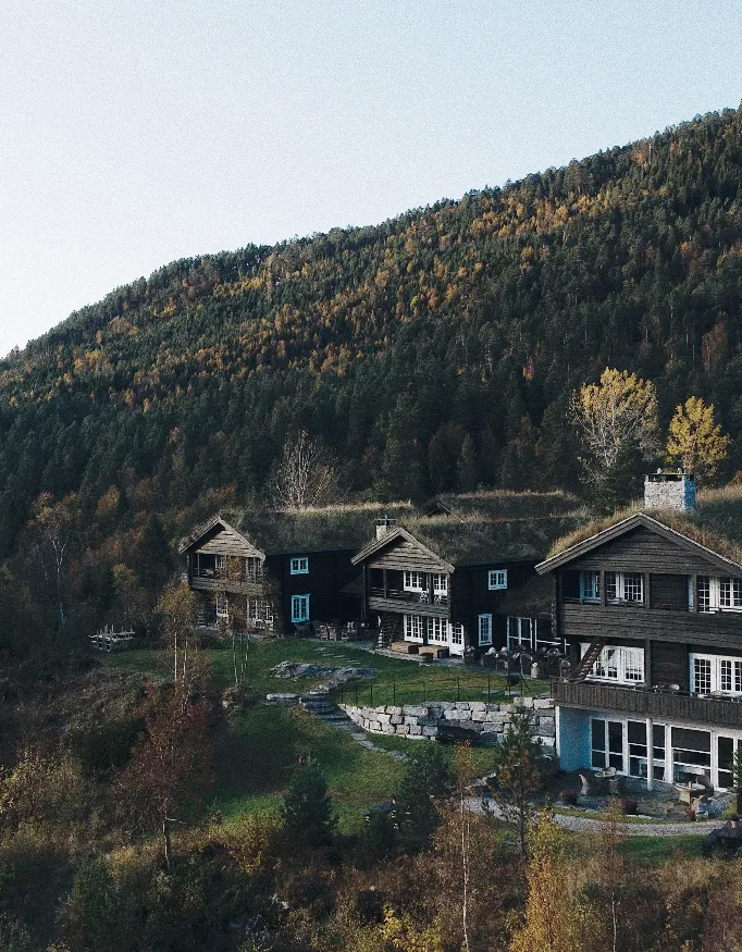 The exterior of the Storfjord Hotel with a forest in the background.