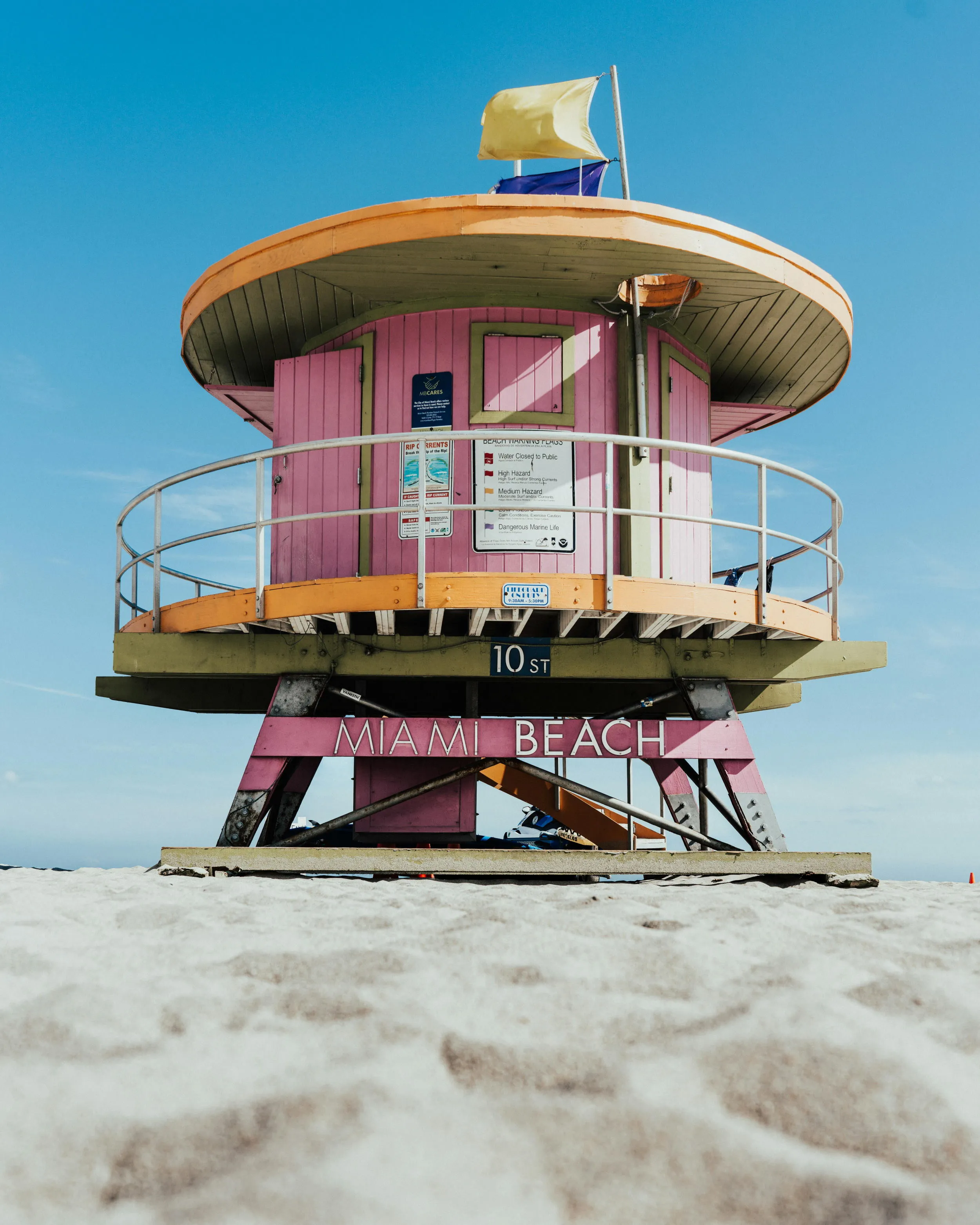 A vibrant pink coastal guard house at Miami beach. During a sunny day with a clear blue sky.