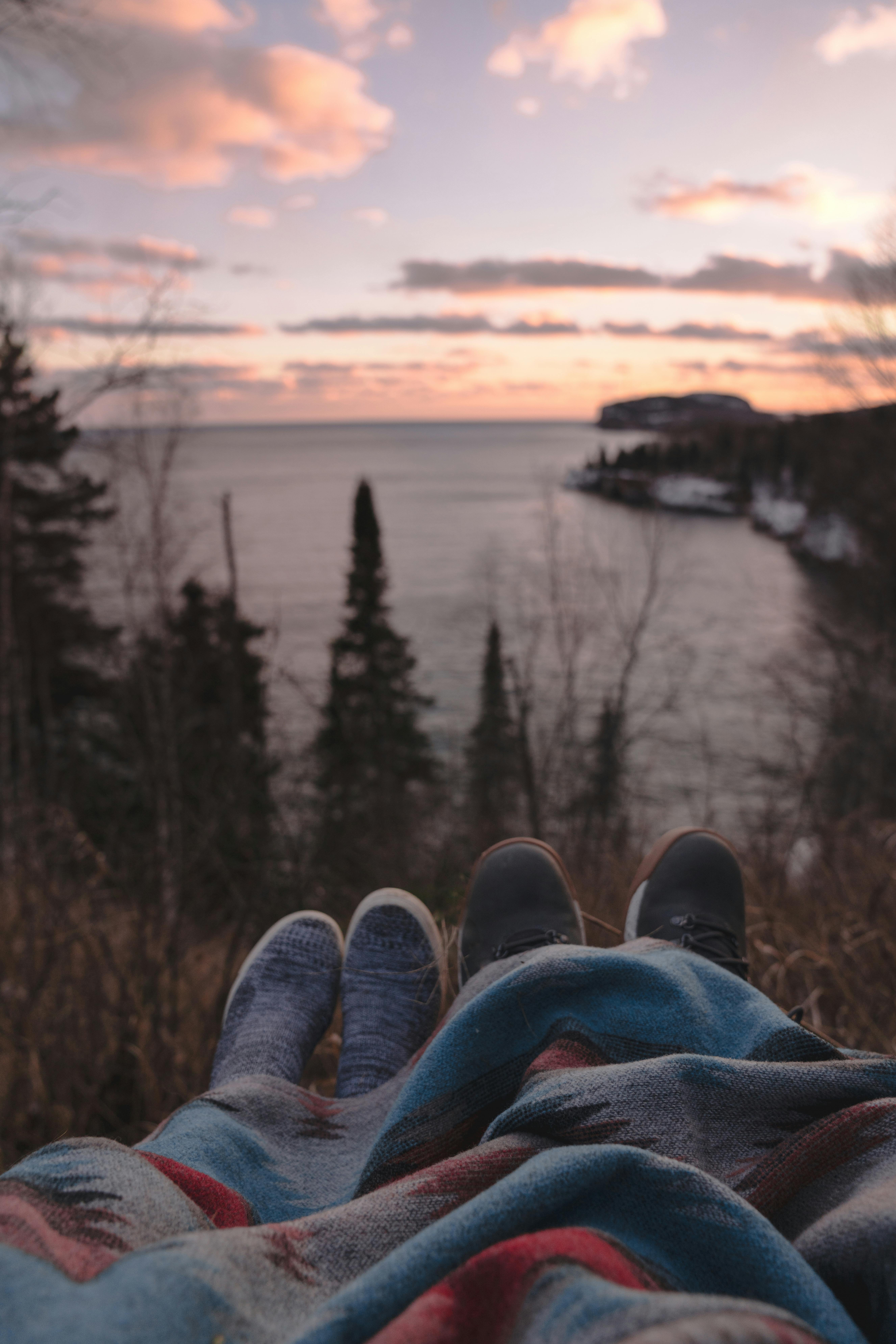 A couple enjoying the sunset near the water in Norway.