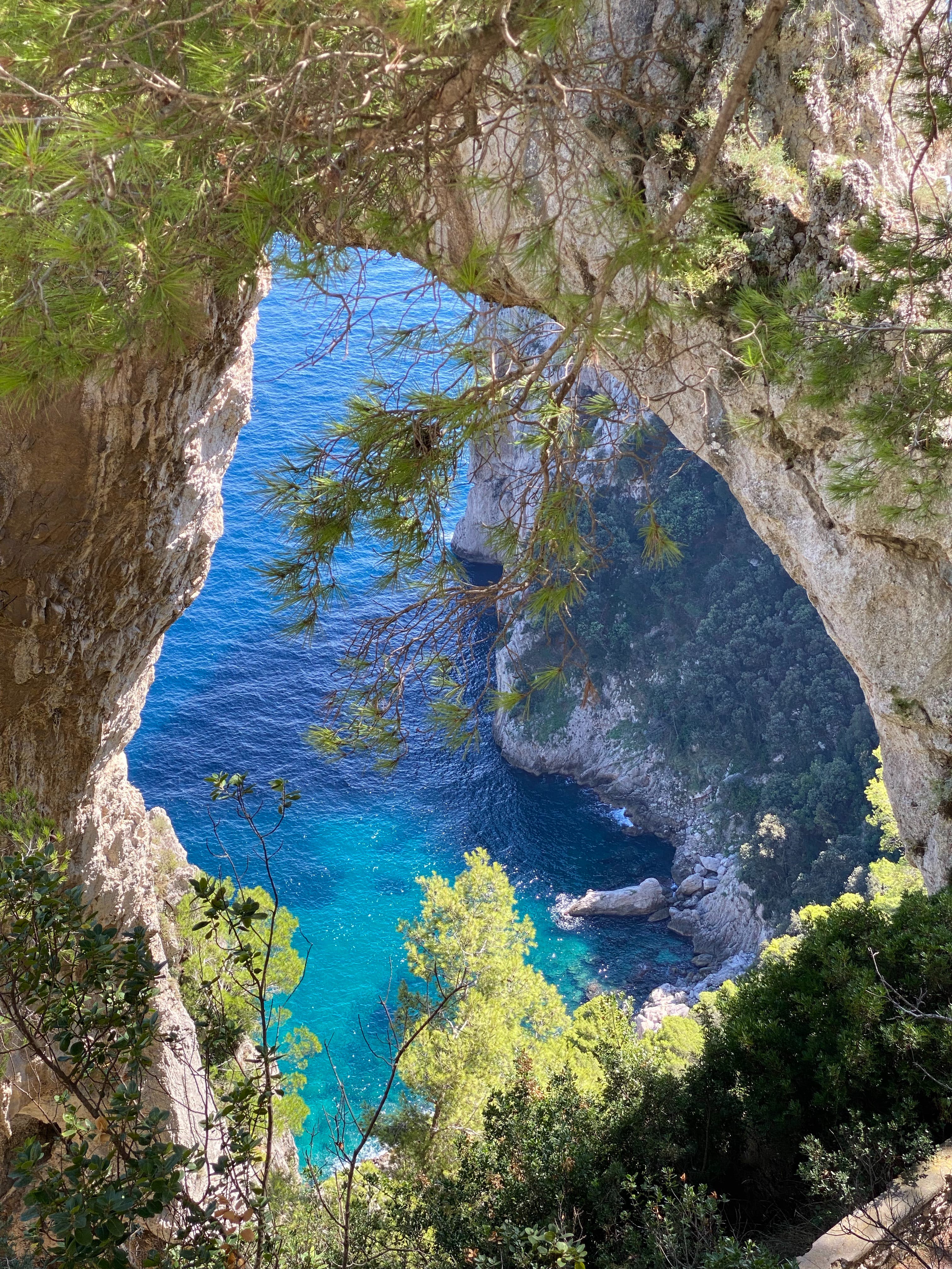 Seeing the sea through a rock formation. Crystal clear water and sunny.