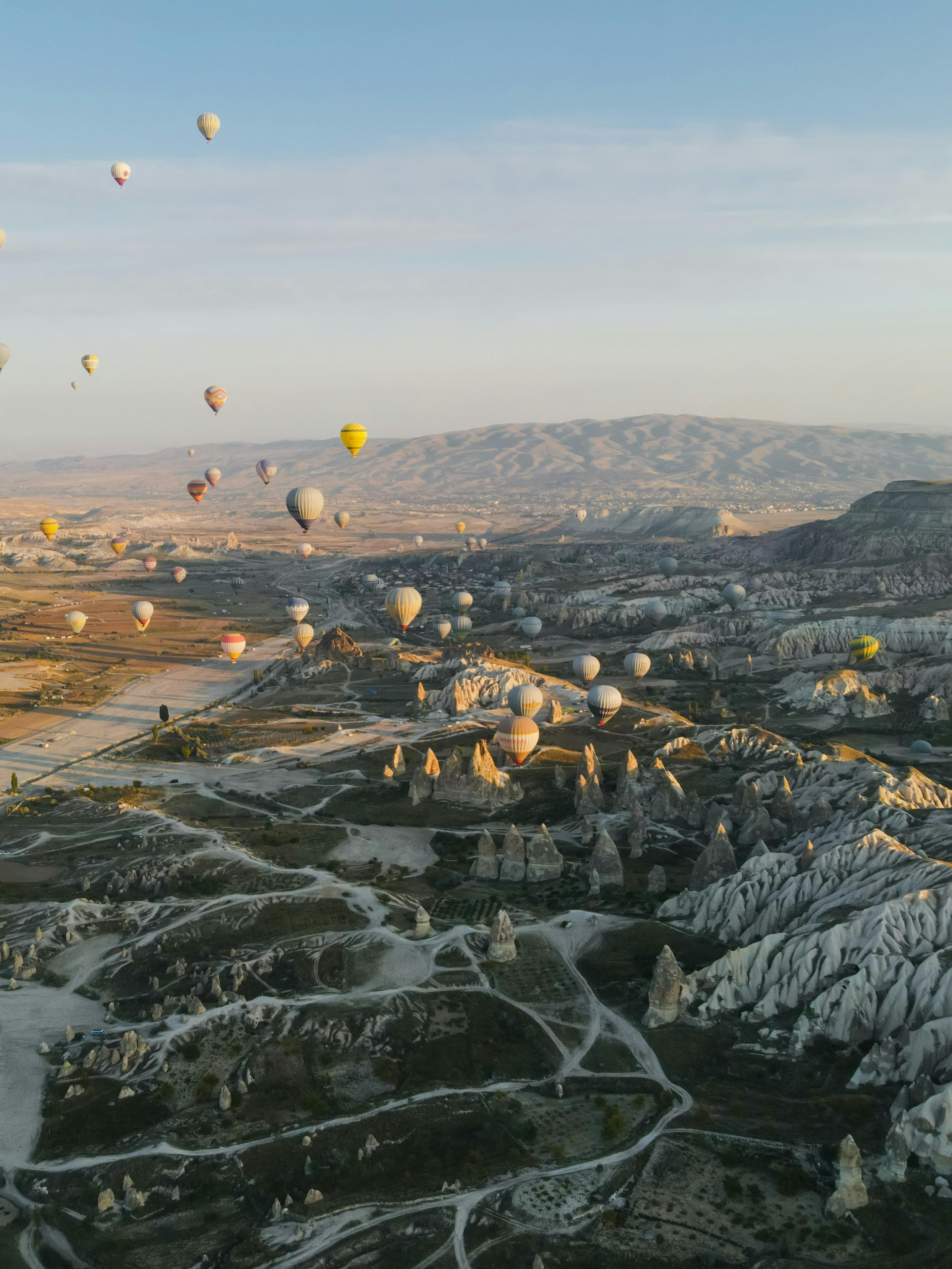 Hot air balloons over Cappadocia during sunrise.