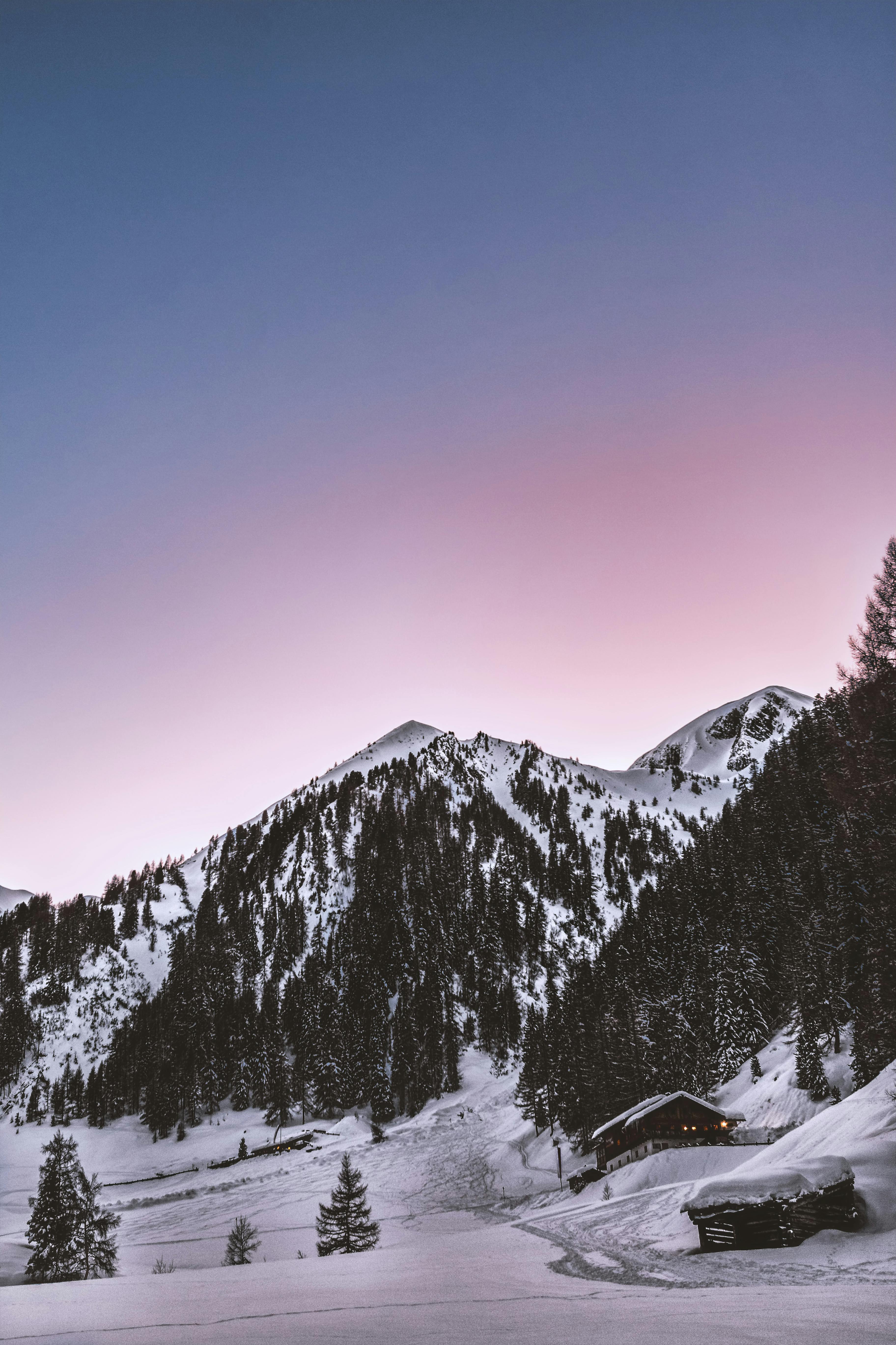 Snowy mountain peak during sunset.