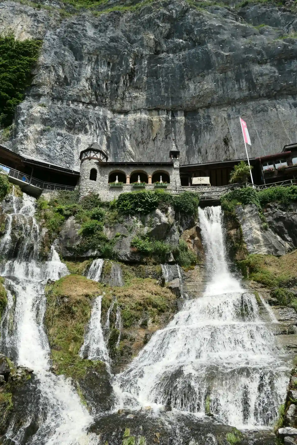 Waterfall on the side of the road in Switzerland.