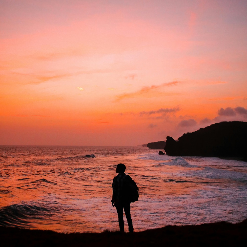 Someone overseeing the sea during sunset.