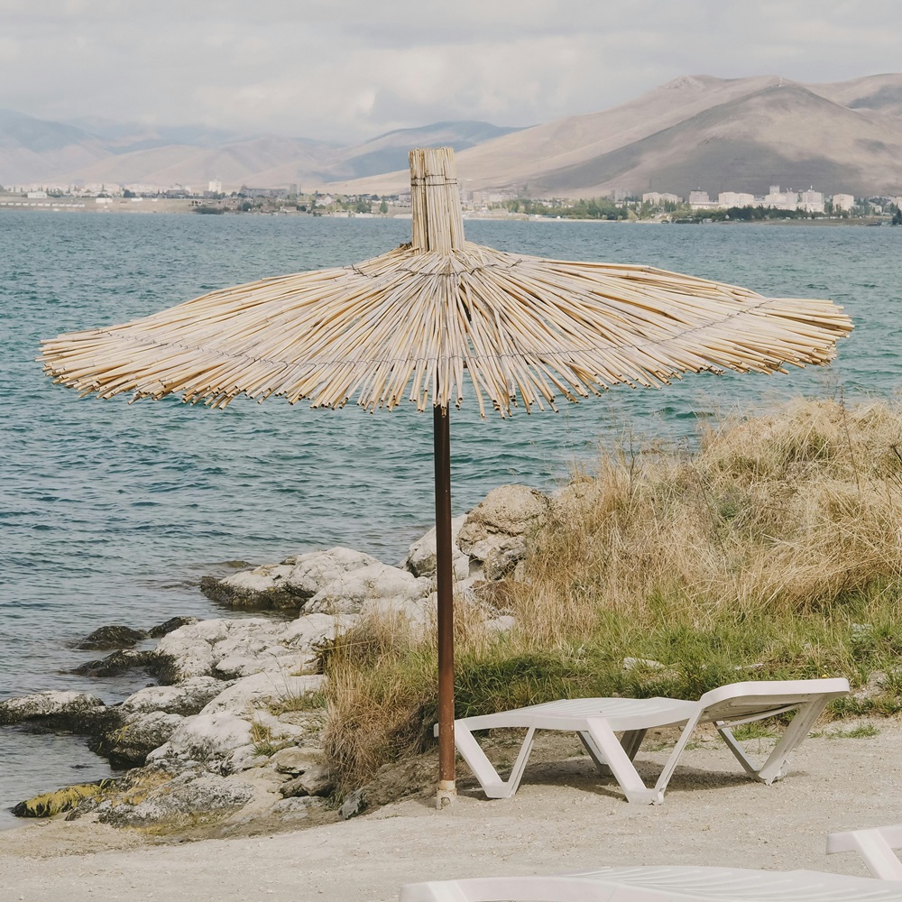 A parasol with a beach bed on the Turkish coast.