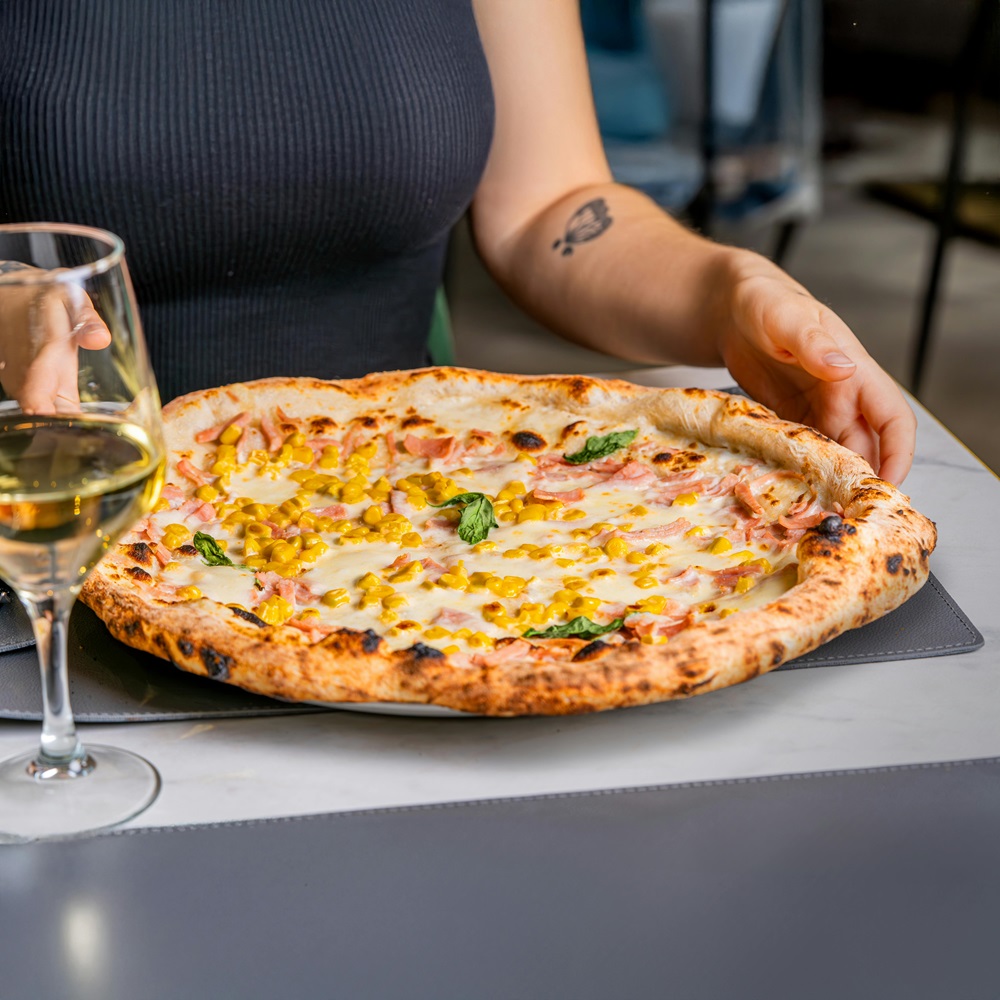 Real Italian pizza with a delicious glass of white wine.