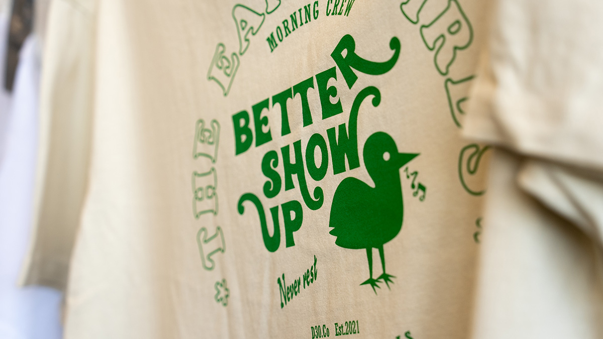 Surfing vibe shirt with green text\