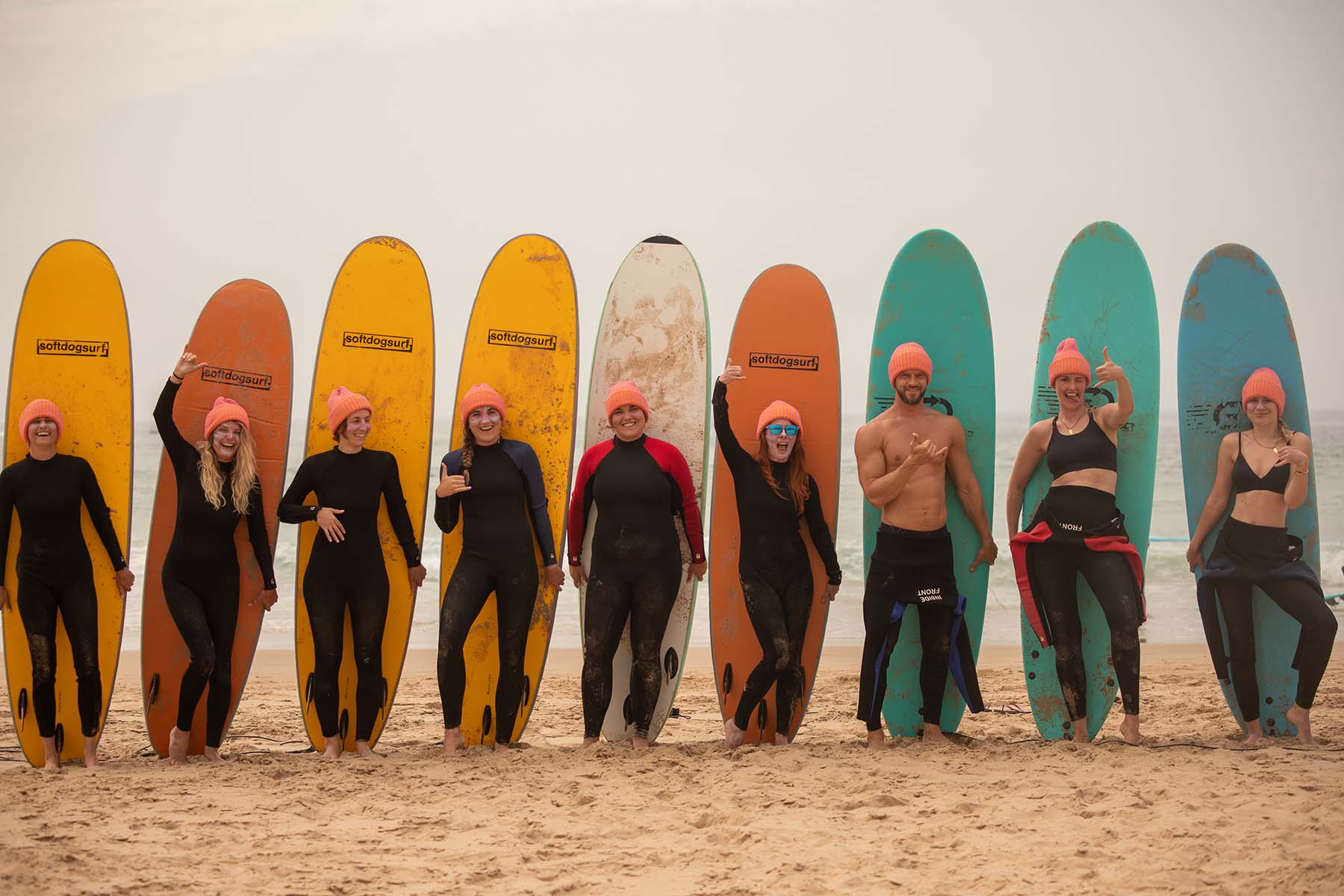 Surfers holding a surfboard