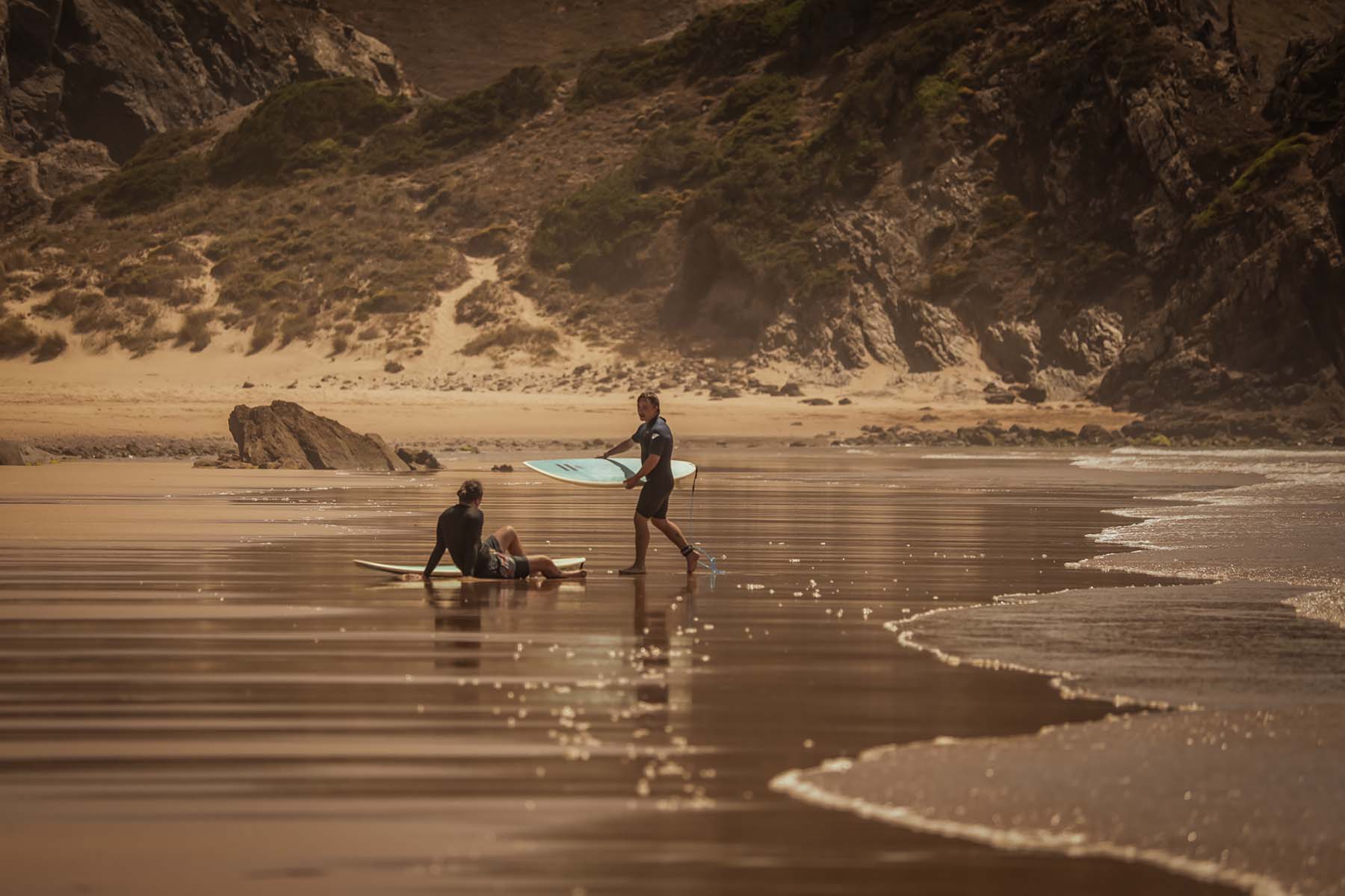 a surfer next to the beach