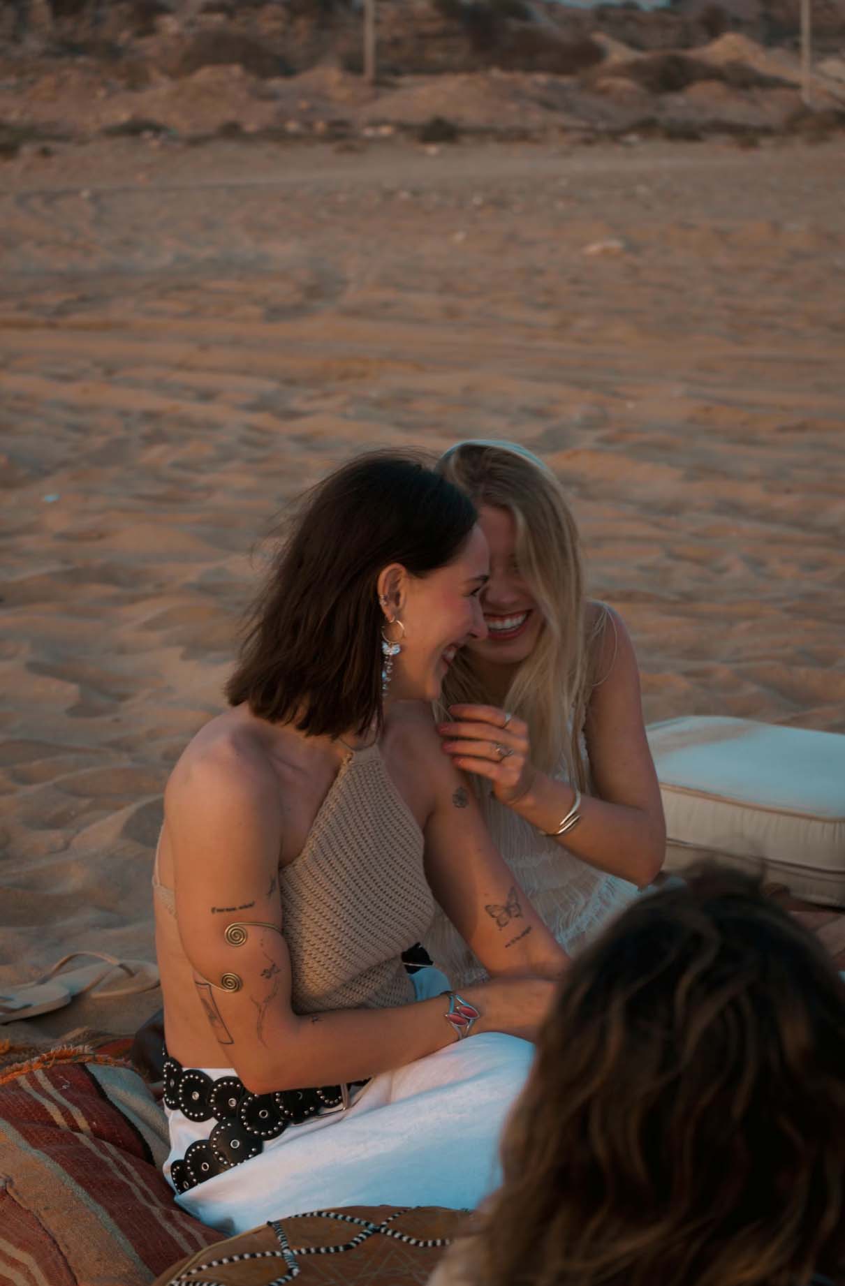 Girls setting on the beach and talking