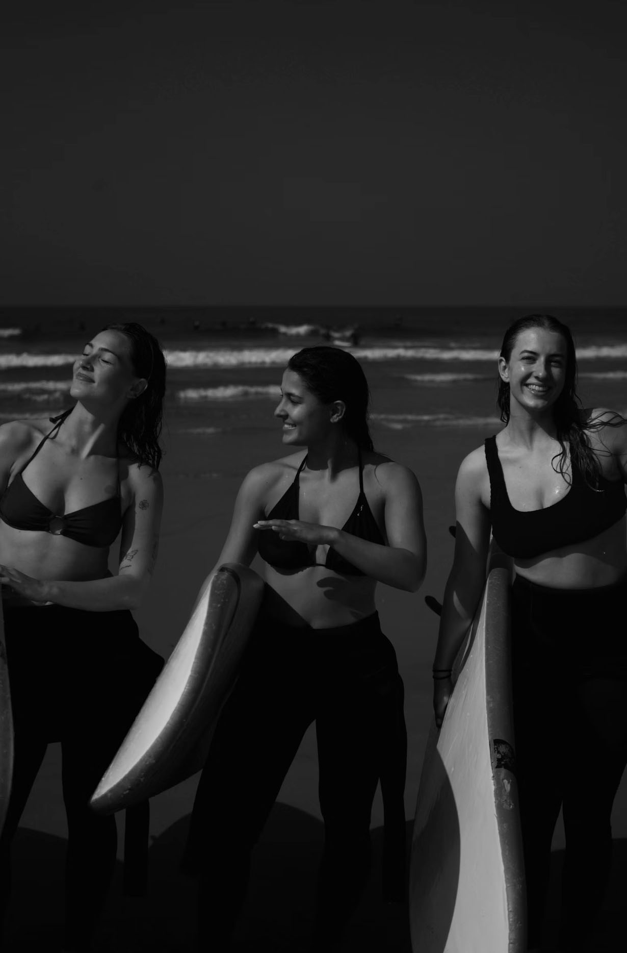 Girls with surfboard on the beach