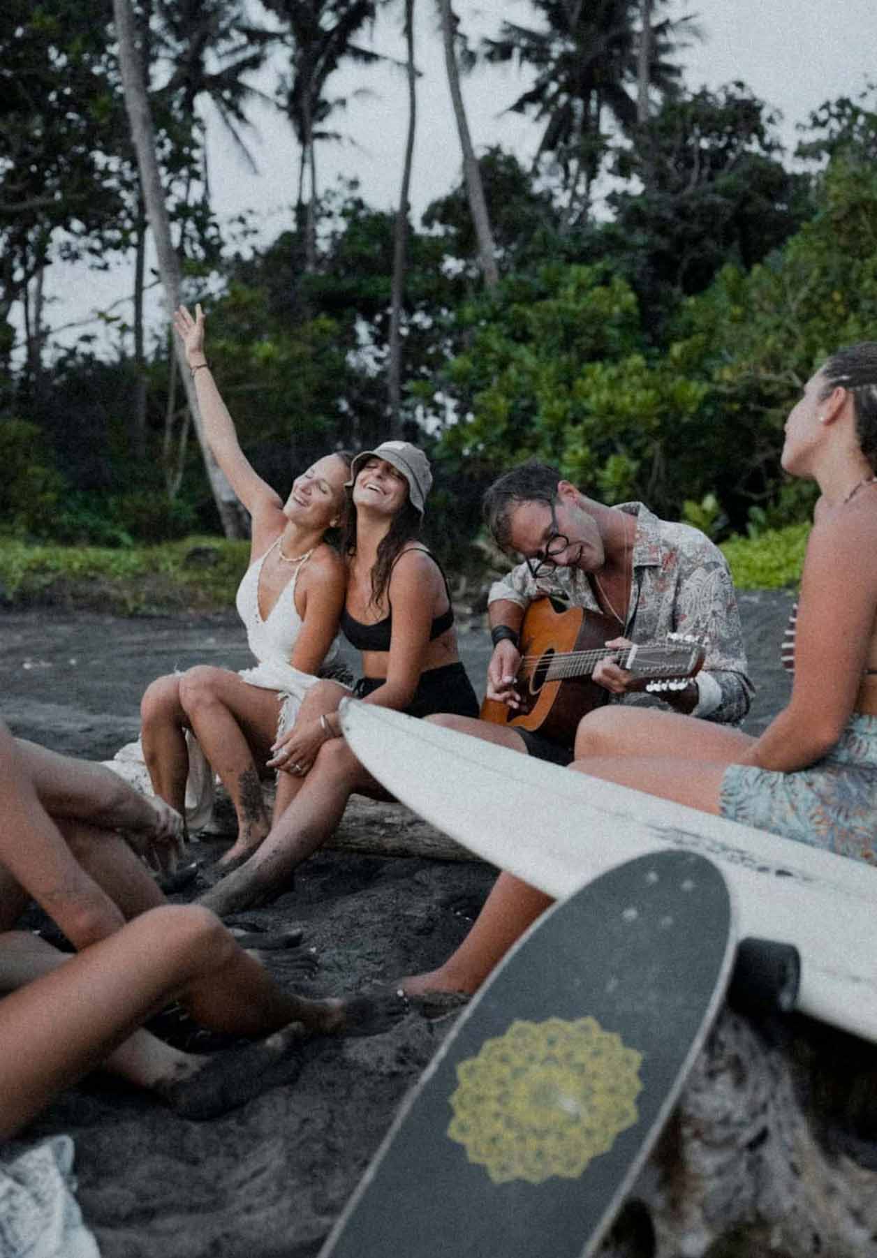 peopel setting on the beach and singing