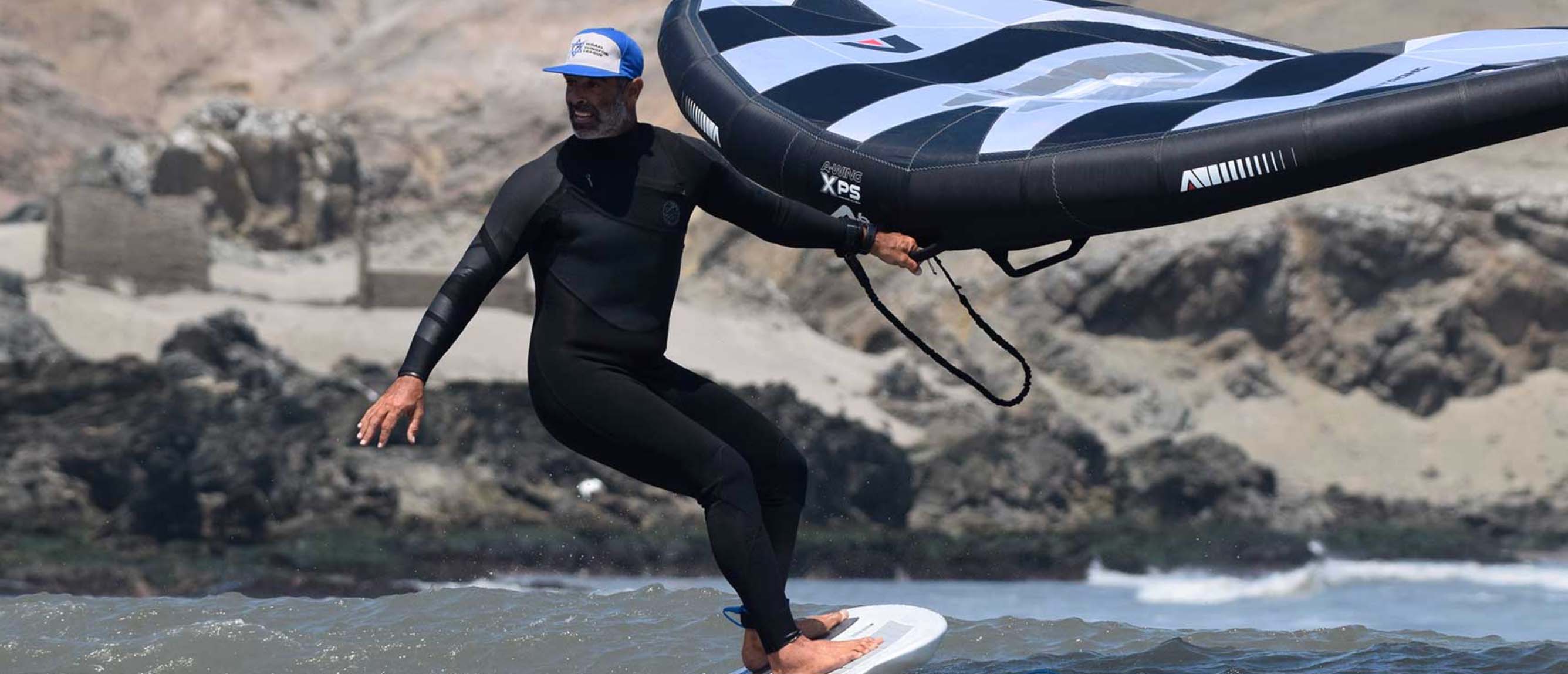 a guy surfing with a wing foil