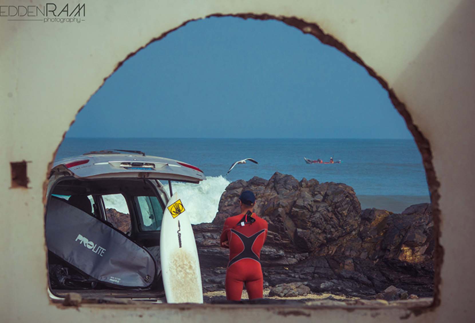 a surfer next to a car in morocoo
