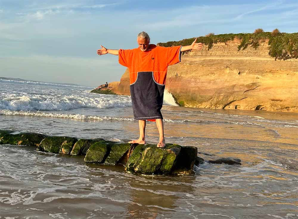 a guy with a surfing puncho
