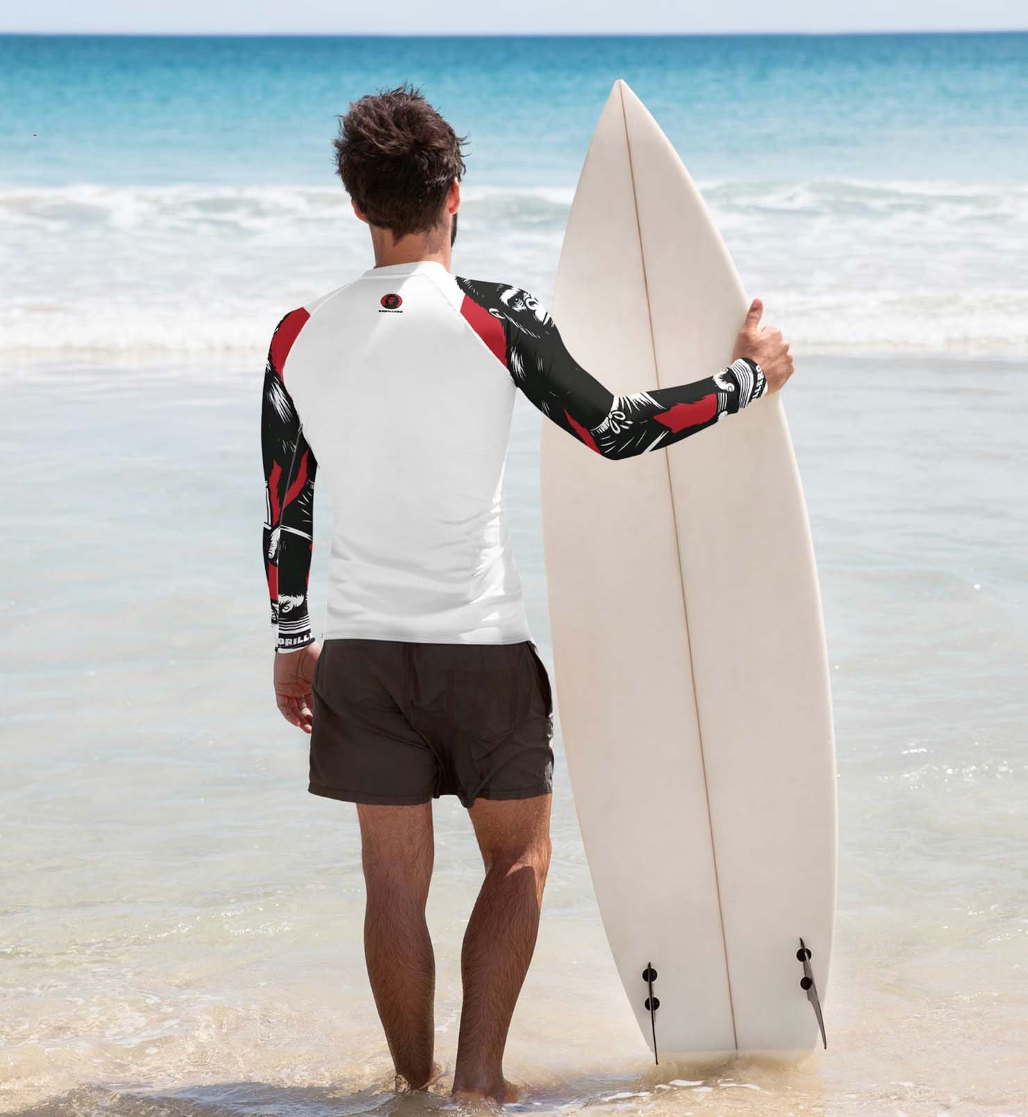 a man holding a surf board on the beach