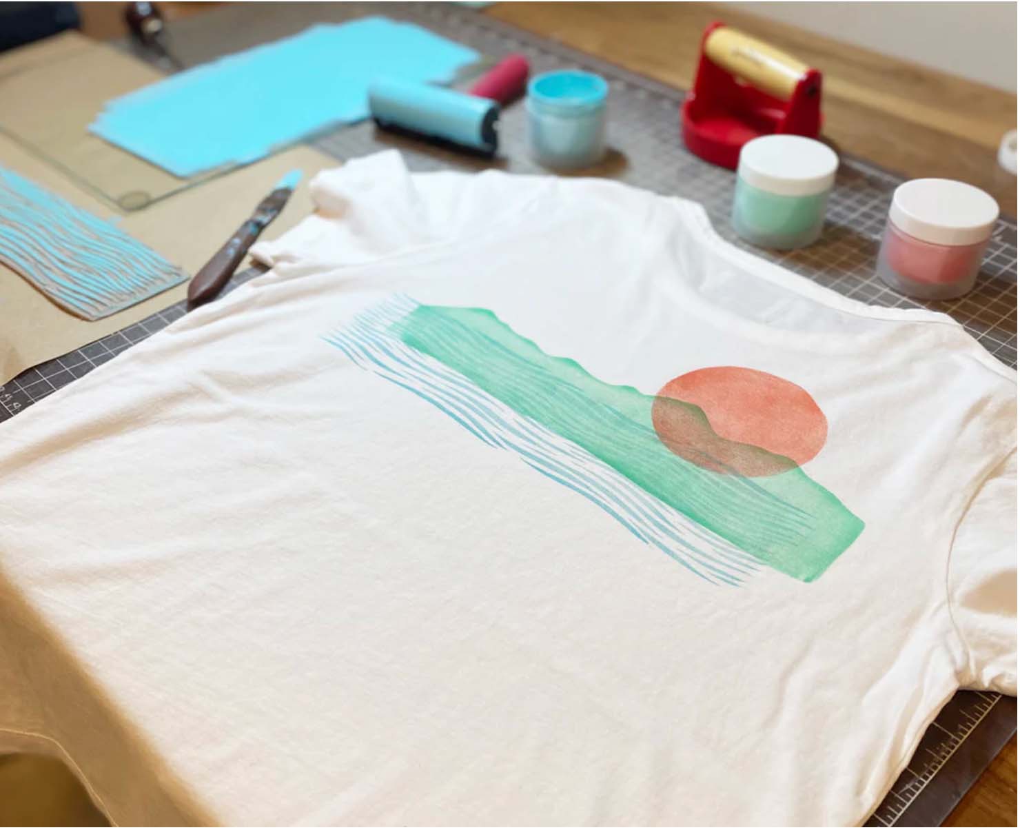 a t shirt with a sun and a waves illustration