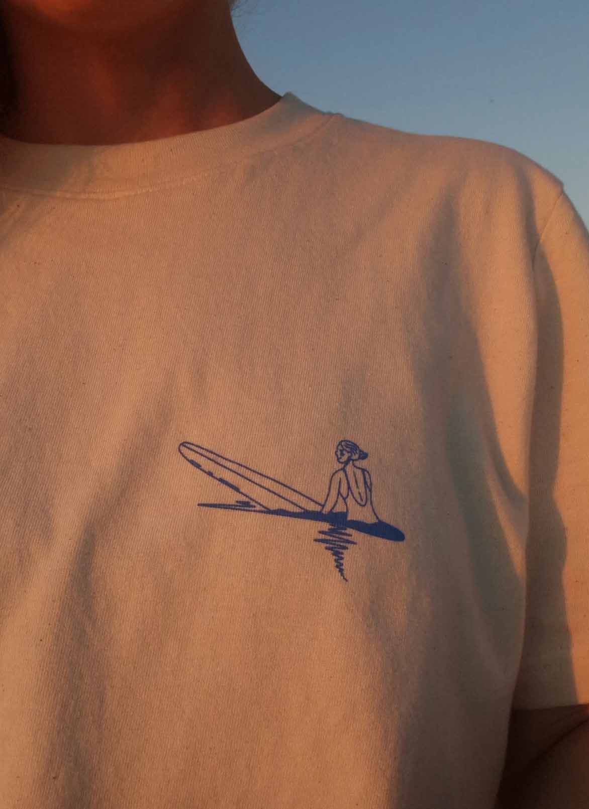 a surfing illustration on a white t shirt