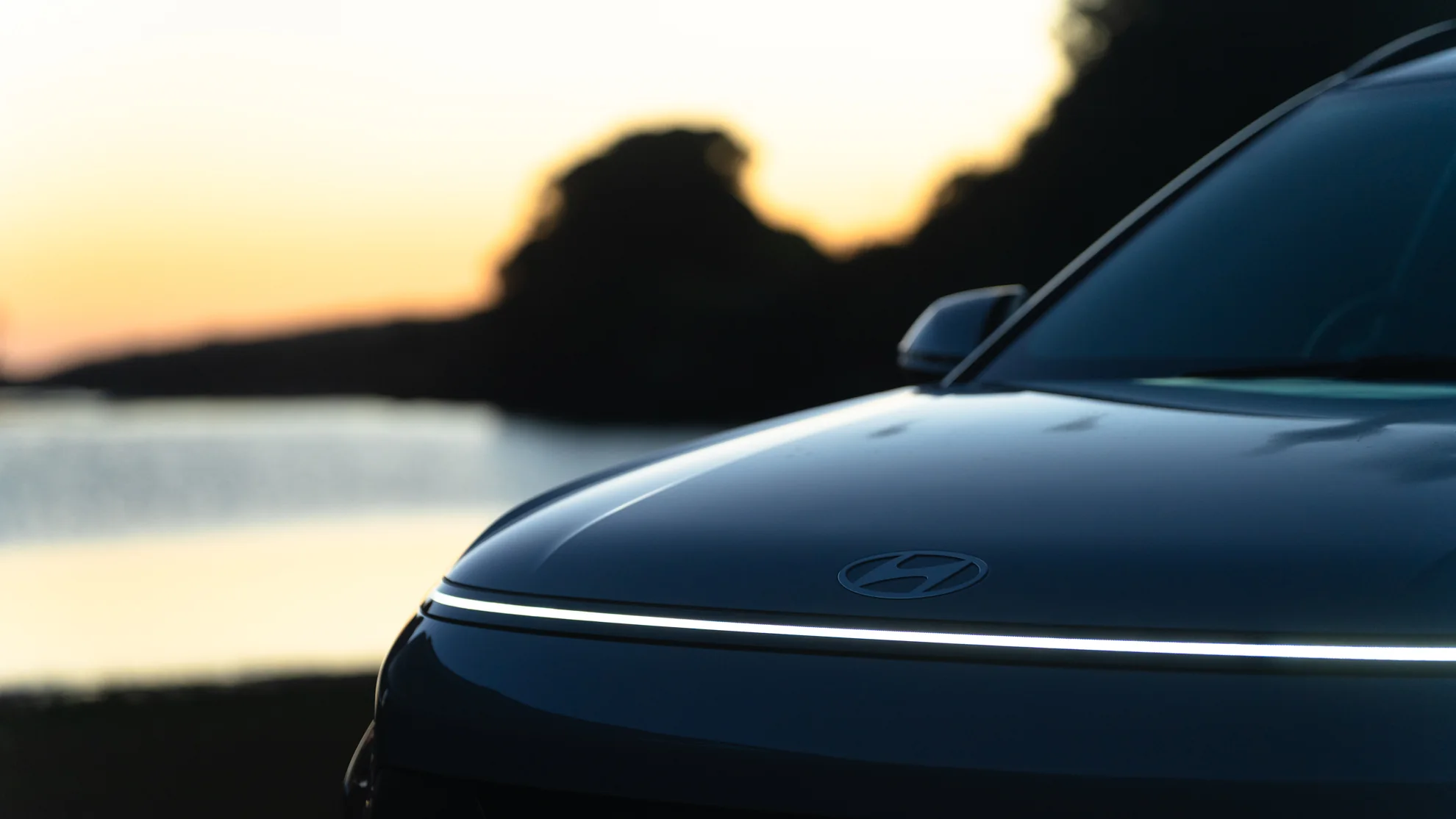 Front of a Hyundai Kona at sunset