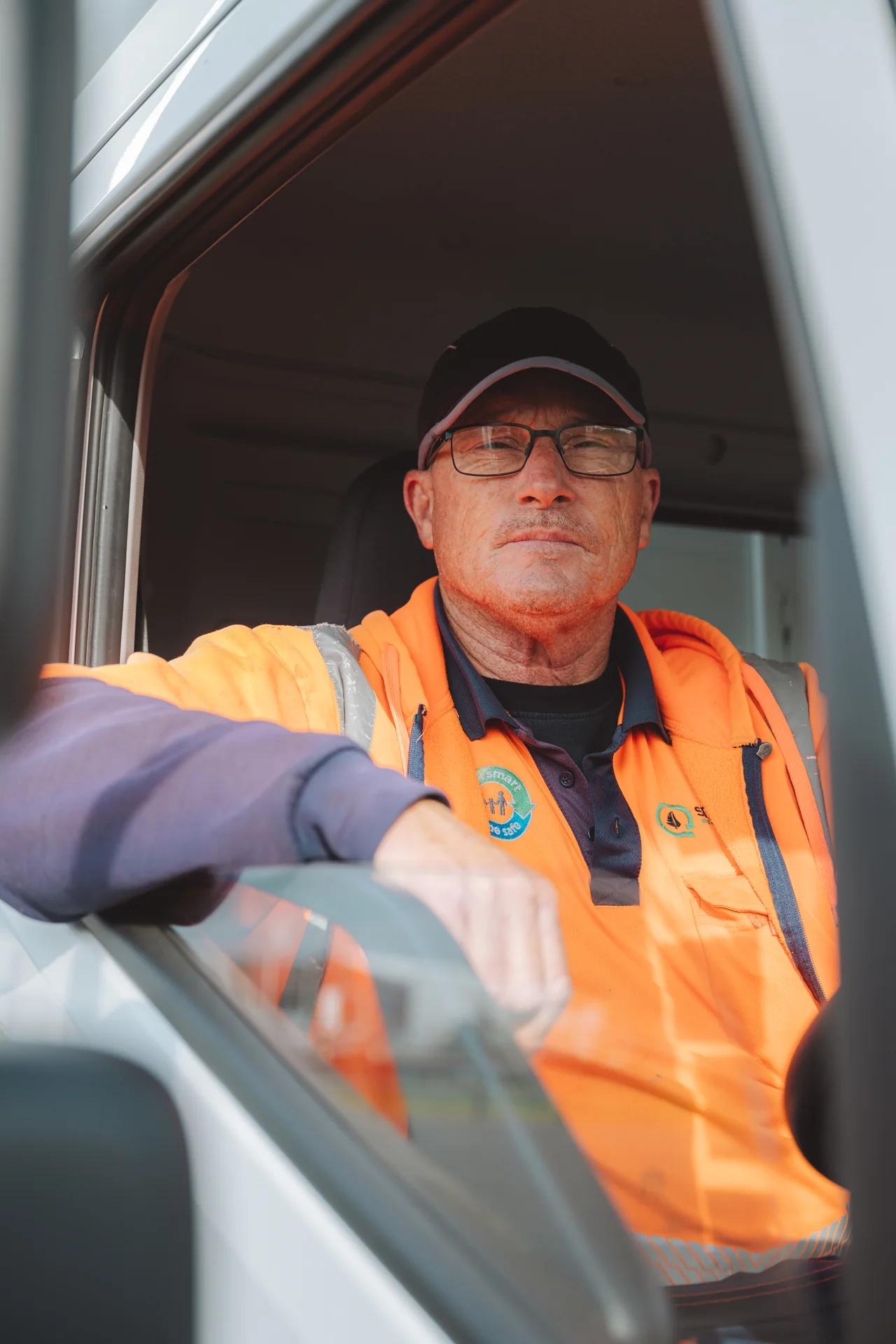 Driver in hi-vis at the wheel of a Hyundai truck