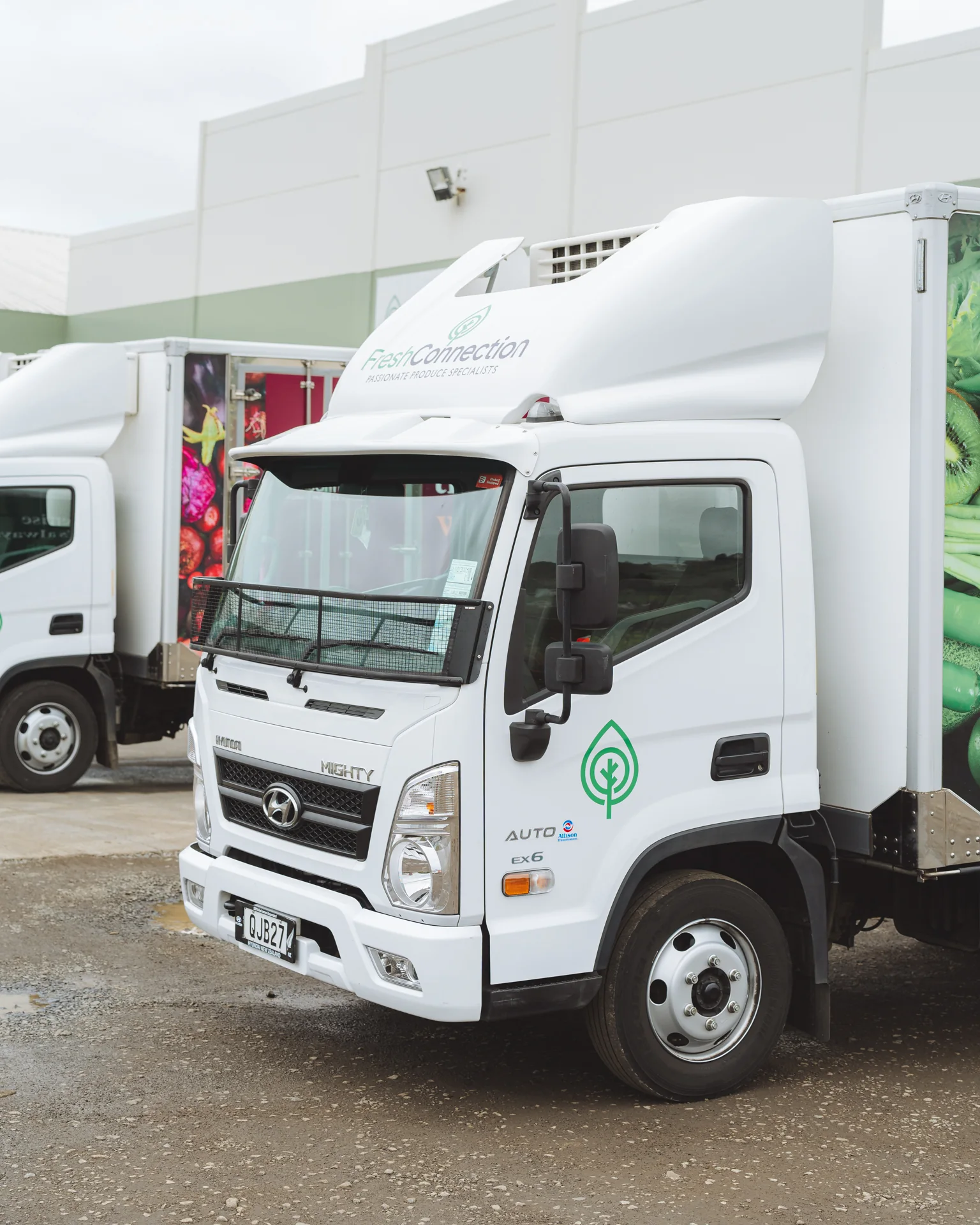 White Hyundai Mighty electric truck in a yard