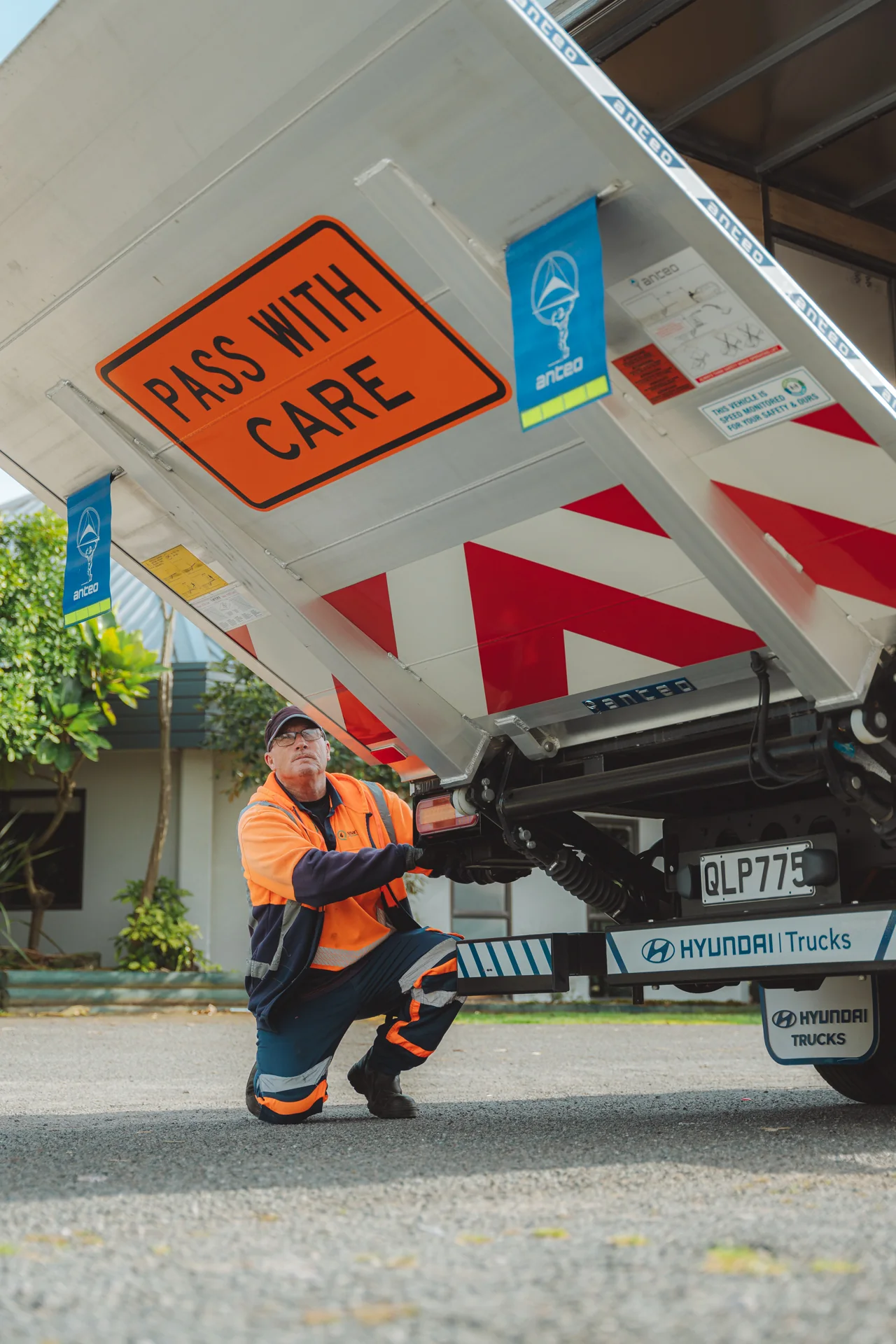 Worker in hi-vis at the back of a Hyundai traffic management truck