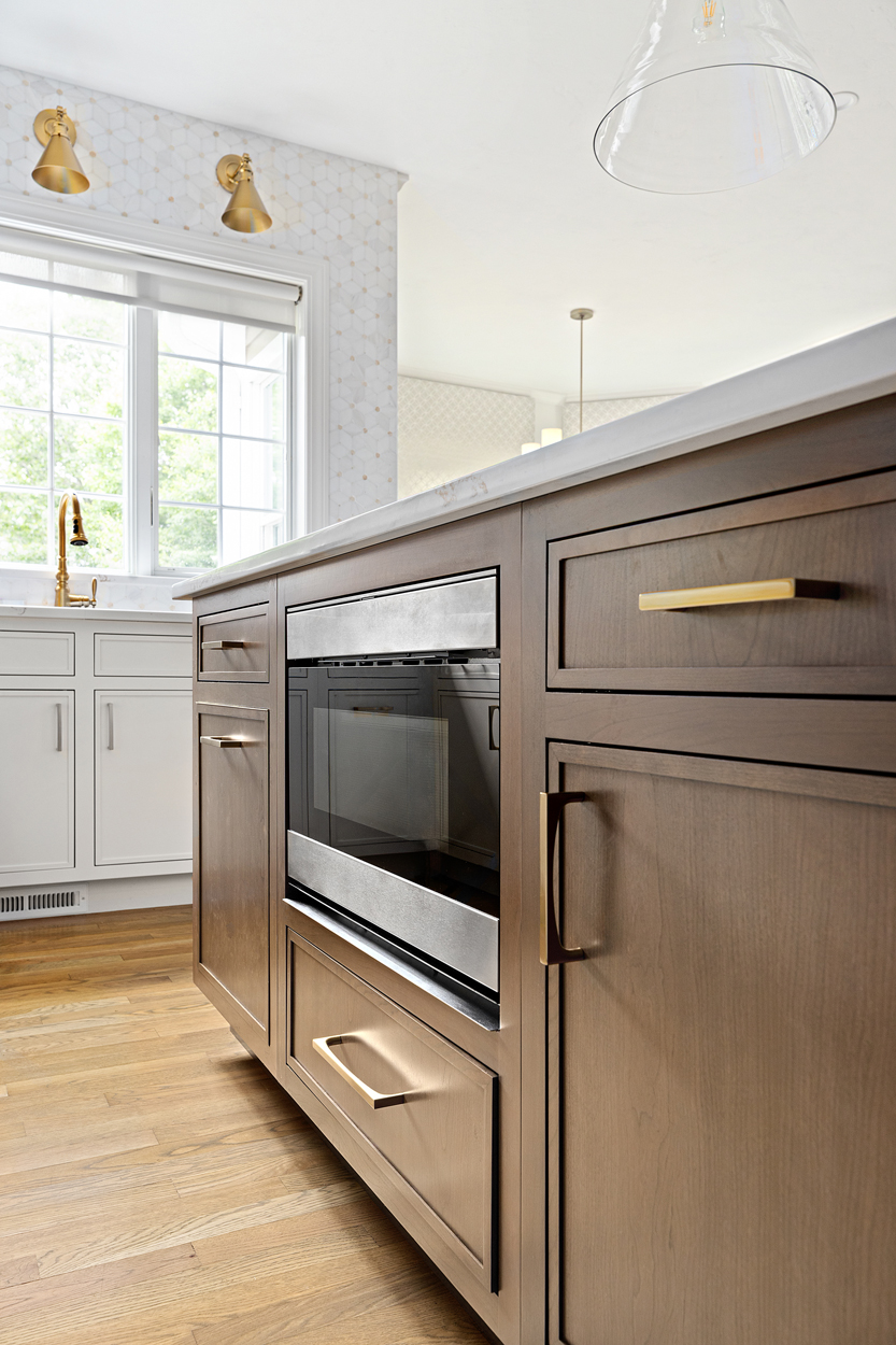 custom cabinetry to fit in everyday kitchen appliances such as the microwave on the island