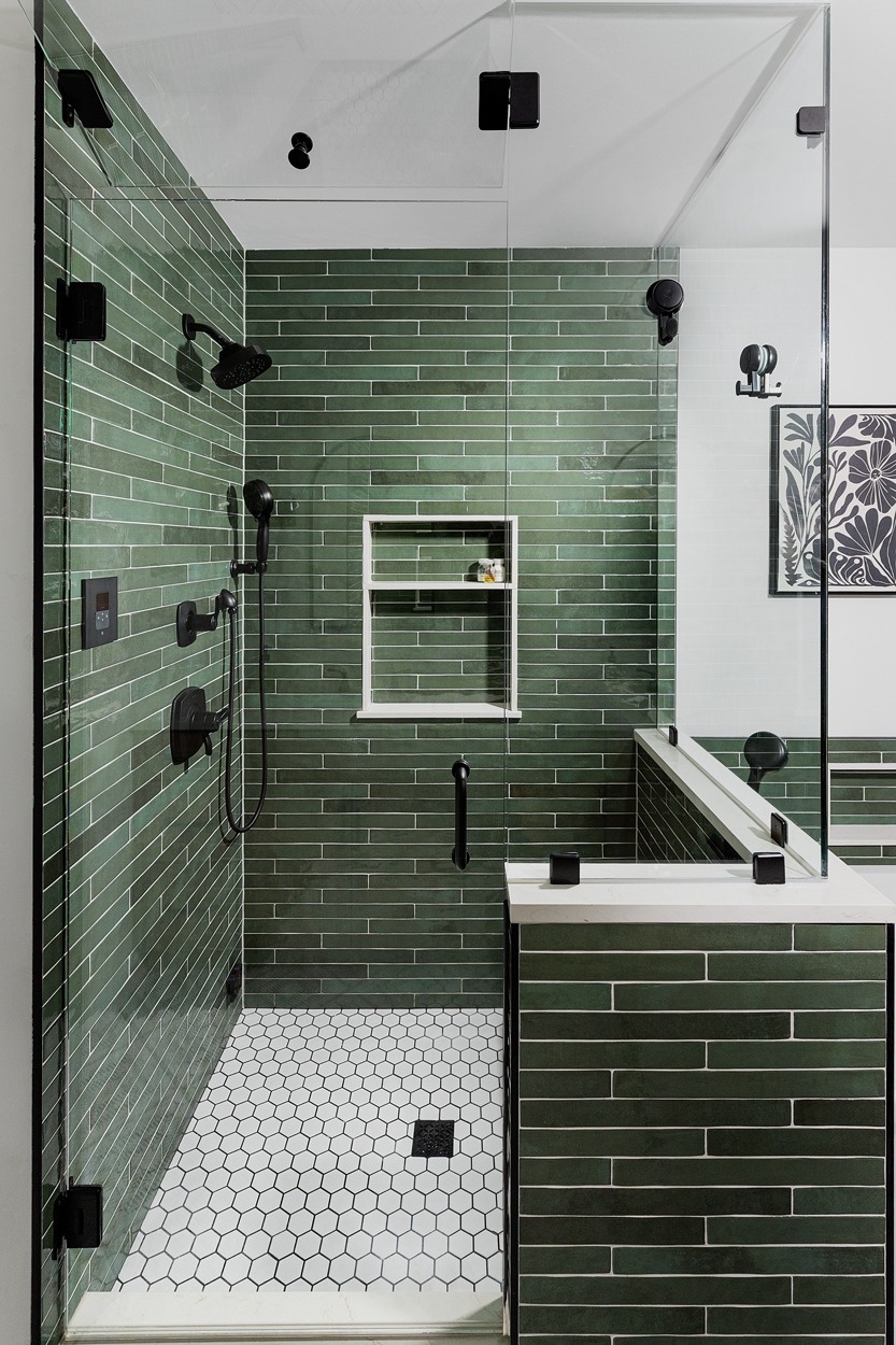 Flamenco Racing Green glossy tile envelops the shower in a rich, mossy hue, its subtle surface variation lending the space an organic depth that shifts and deepens with the light. 