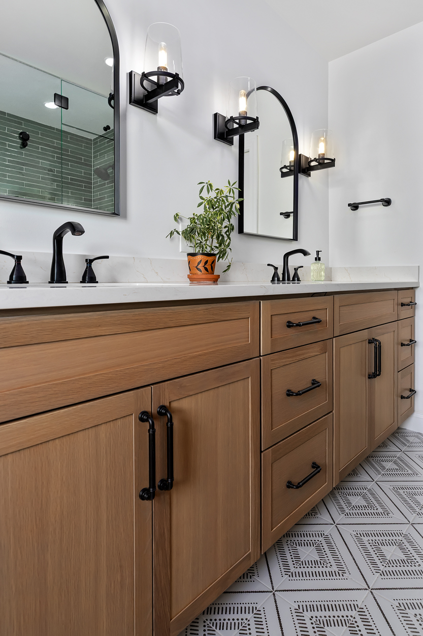 White oak cabinetry in a coriander stain brings an airy, rustic quality to the space, grounded by deep base cabinets with full-extension drawers that keep everyday essentials close at hand