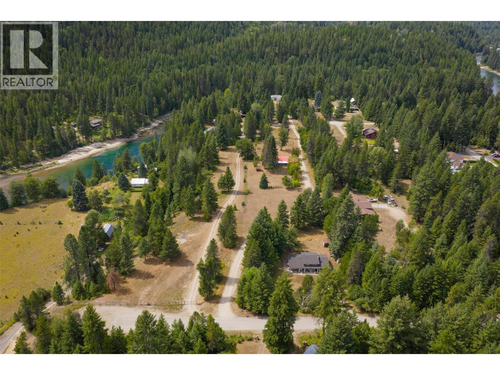 4.74 Acre property with three dwellings and 151 feet of river frontage.