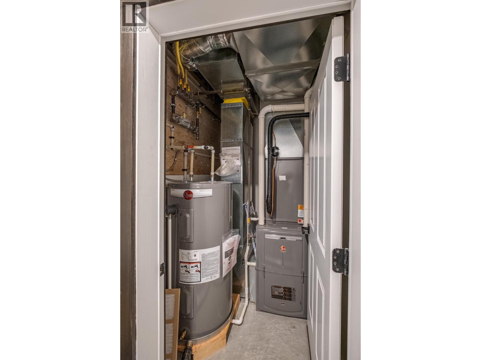 Mechanical room: natural gas furnace, electric water tank, AC.