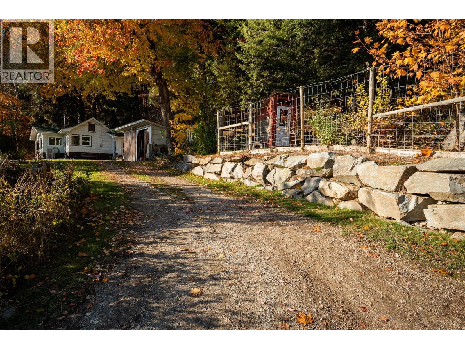 Driveway leading to house with new French draining retaining wall