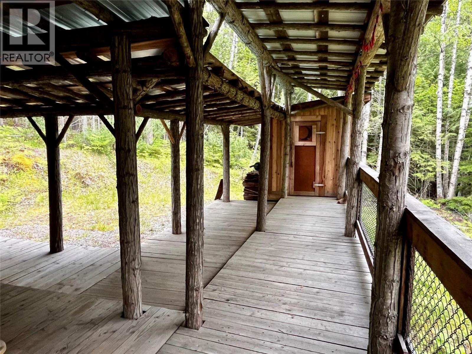 Covered walkway to outhouse with running water
