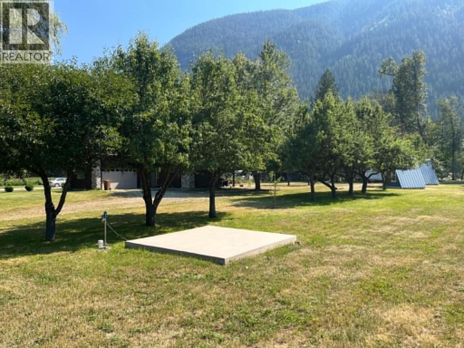 Cement pad for eventual electrical power house. Also location of water tap.