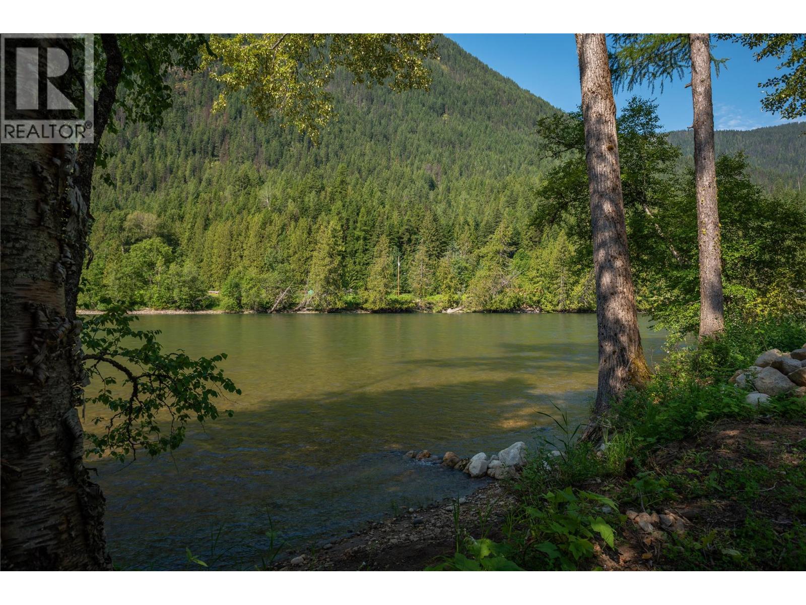 Slocan River view from the beach towards Slocan Park Bridge.
